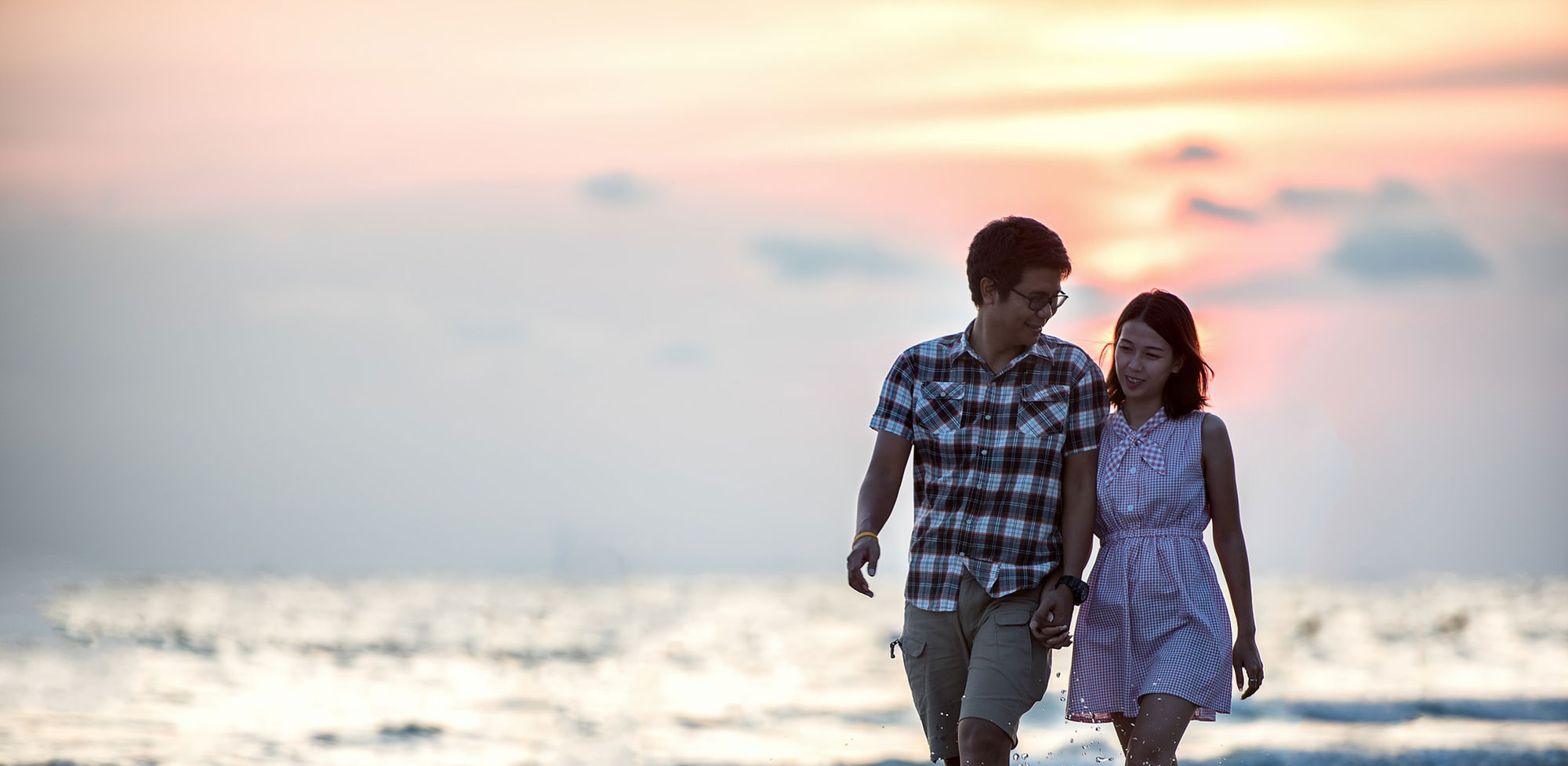 Couple Holding Hands In Sunset